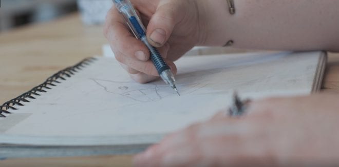 An artist works on a drawing