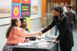 SCFD employees welcome job seeker at job fair.